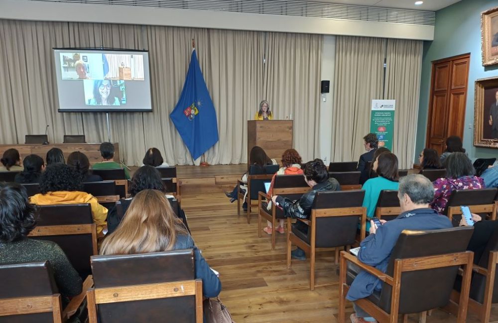 En una panorámica de la sala, al fondo se ven proyectadas las invitadas internacionales por videollamada.